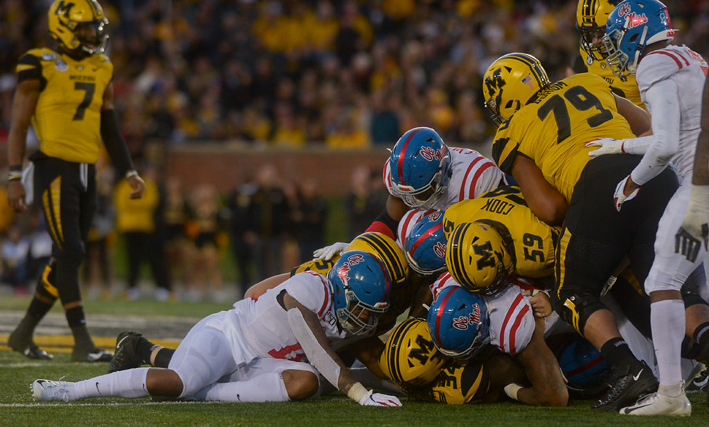 Athletes pile on top of Missouri running back Larry Rountree III